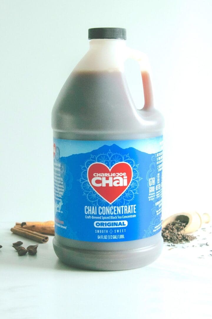 A gallon of chai concentrate sitting on top of a table.