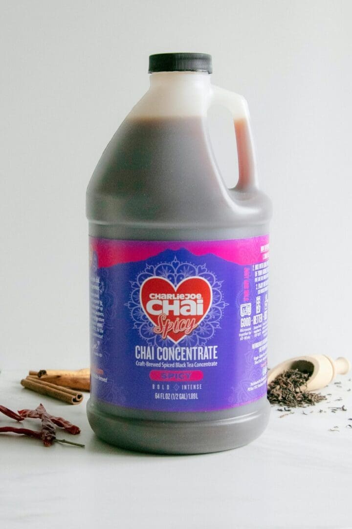 A bottle of chai concentrate sitting on top of a table.